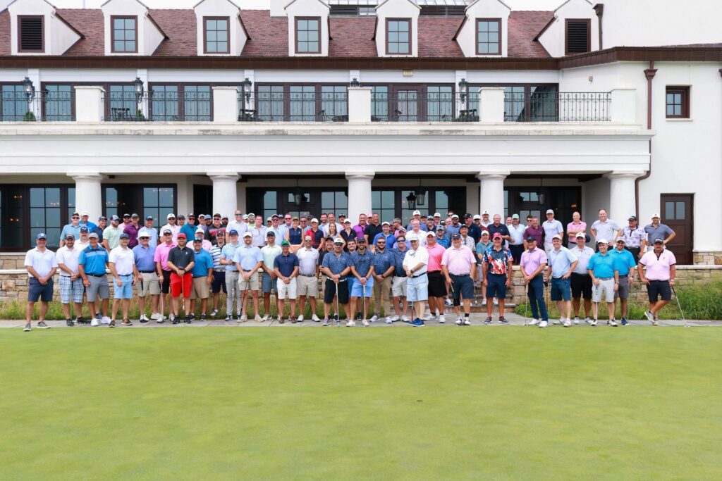team in front of golf clubhouse