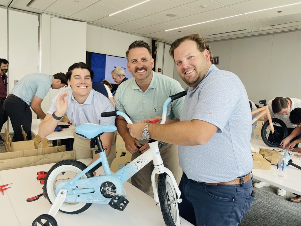 team putting bikes together